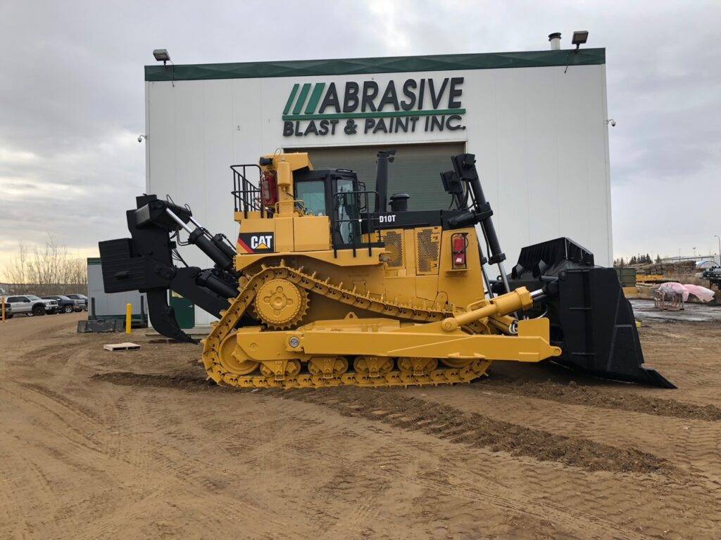 Finished Finning Cat Bulldozer in front of Abrasive Blast & Paint Inc. Building